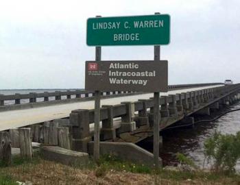 Sign for the Lindsay C. Warren Bridge welcoming travelers the Alligator River Bridge.