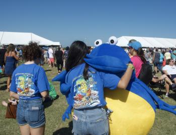 Outer Banks Seafood Fest mascot gives volunteer a hug.