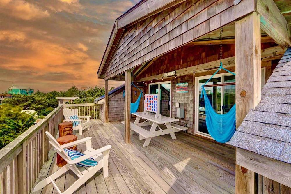 balcony with hammock and chairs at sunset